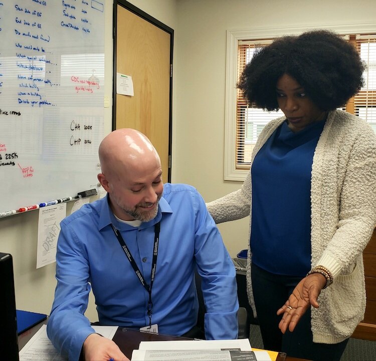 Chris Cook discusses outreach strategies with Dorline Lucien, Haitian-Creole interpreter at the Clark County Health Department. 