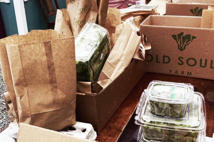 Vendors for Champaign Locally Grown receive orders online and sort items for weekly pickup.